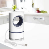 White and blue air purifier on a white surface with a blurred kitchen background