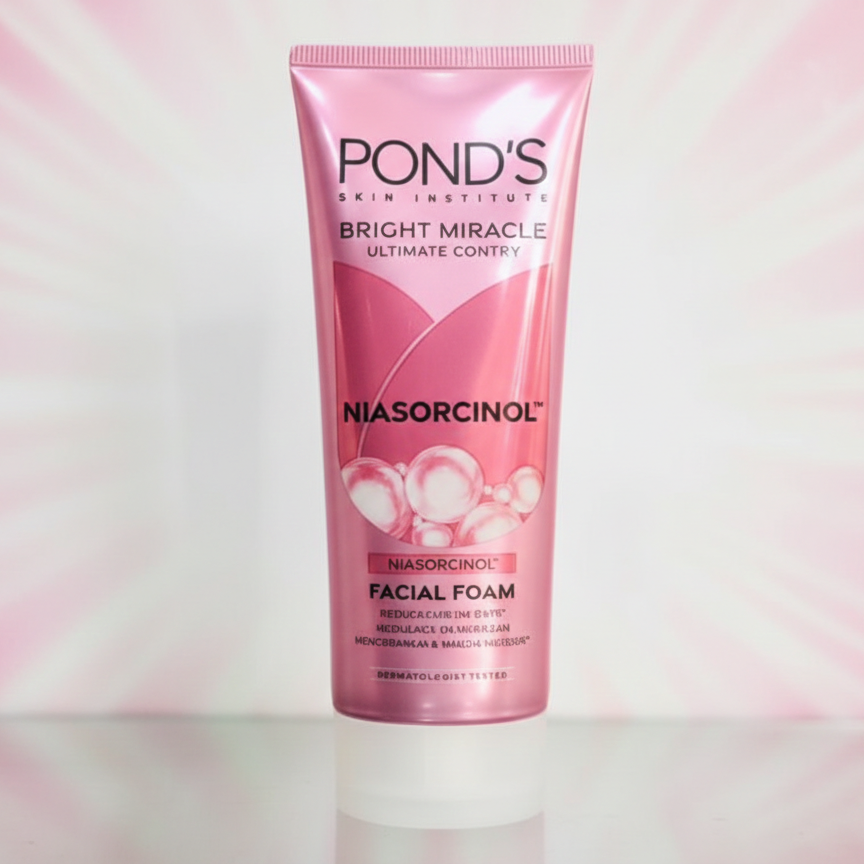 Pond's Bright Miracle Niasorcinol Facial Foam tube on a pink gradient background