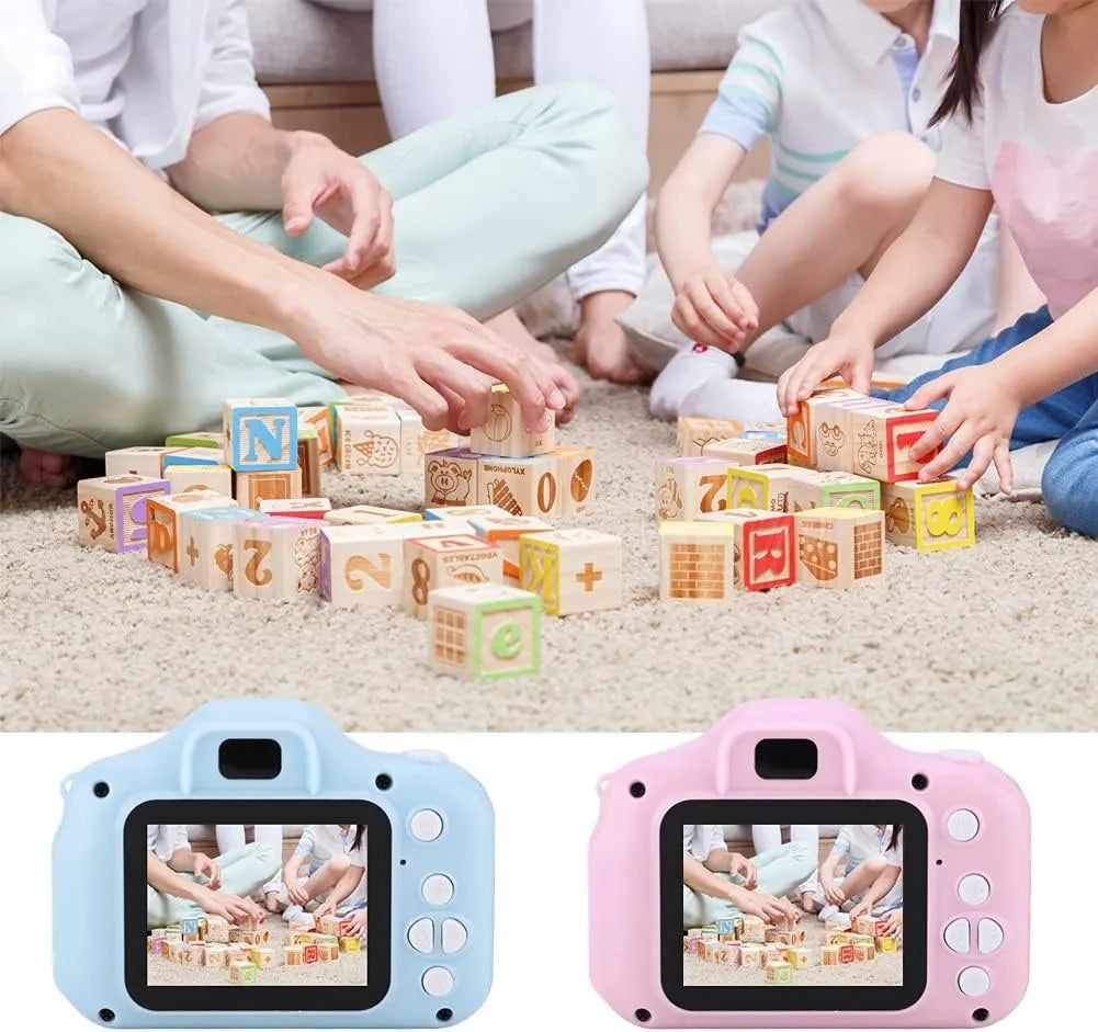 Children playing with colorful blocks on the floor, with two digital cameras displayed at the bottom.