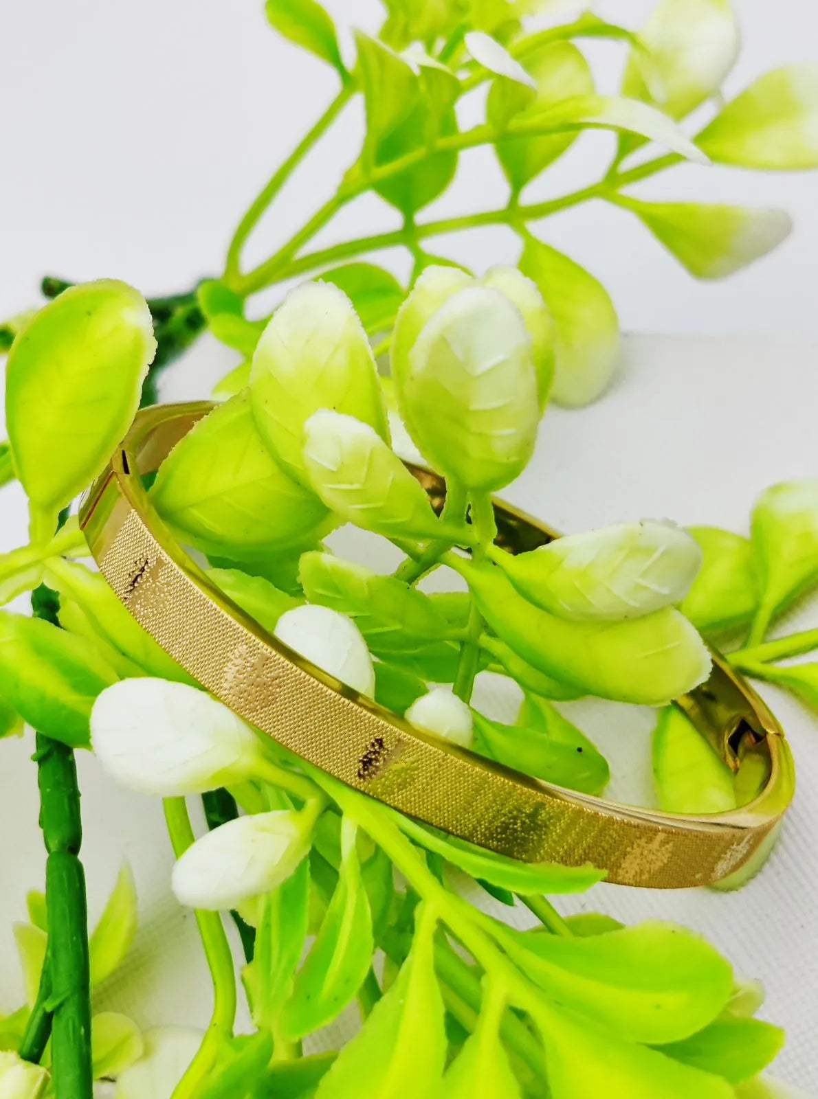 Adjustable gold bangle bracelet featuring a timeless design for casual and formal occasions.