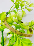 Adjustable gold bangle bracelet featuring a timeless design for casual and formal occasions.