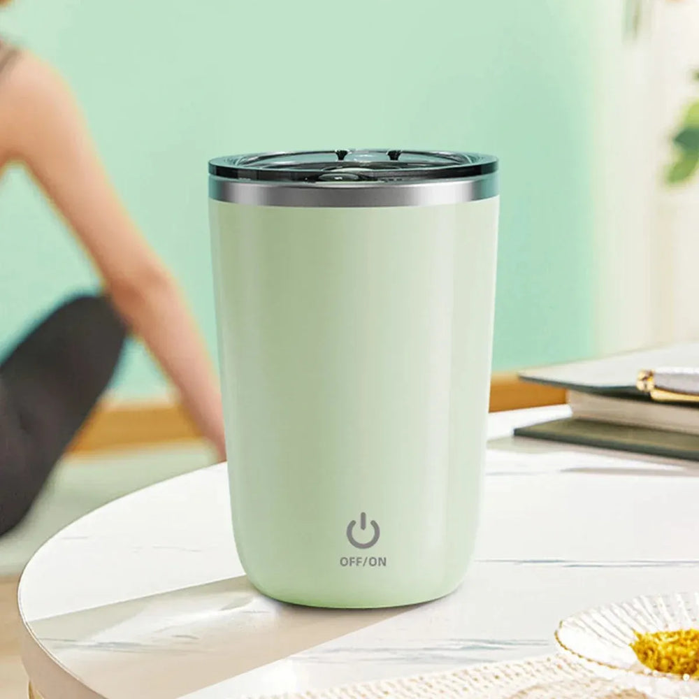Light green tumbler with power symbol on a table with a blurred background