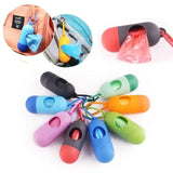 Colorful plastic waste bag holders with keychains on a white background