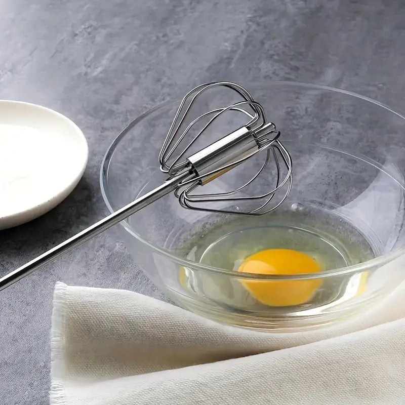 Big manual hand push egg whisk mixer for quickly mixing eggs, batter, and cream.