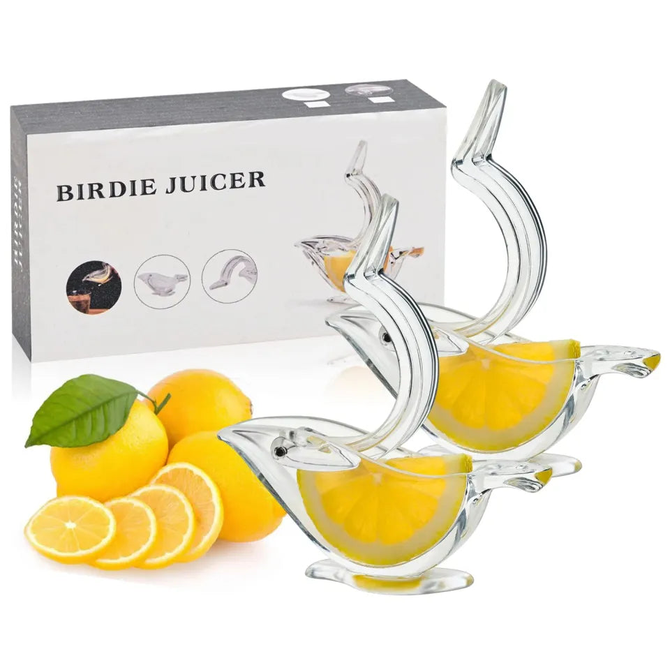 Clear bird-shaped lemon juicer with lemons and packaging labeled 'Birdie Juicer' on a white background.