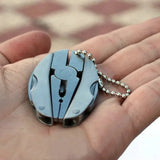 Multitool keychain held in a hand with a blurred background