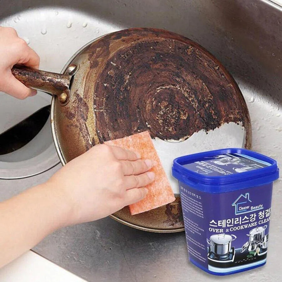 Person cleaning a rusty pan with a scrubber, next to a container of cleaner.