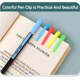 Colorful pen clips on an open book with a blue pen.