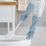 Person cleaning a toilet with blue gloves in a bathroom setting