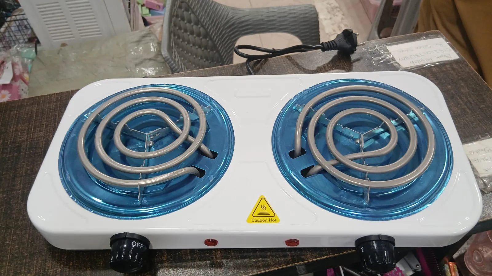 Portable double hot plate stove suitable for home kitchens, camping, and temporary cooking spaces.