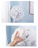 Two-panel photo showing a white protective fan cover with a gray and beige animal print, demonstrated with a small white fan in a room setting. The top panel shows the cover fitted around the fan, and the bottom panel shows a hand pulling the elasticized edge of the cover.