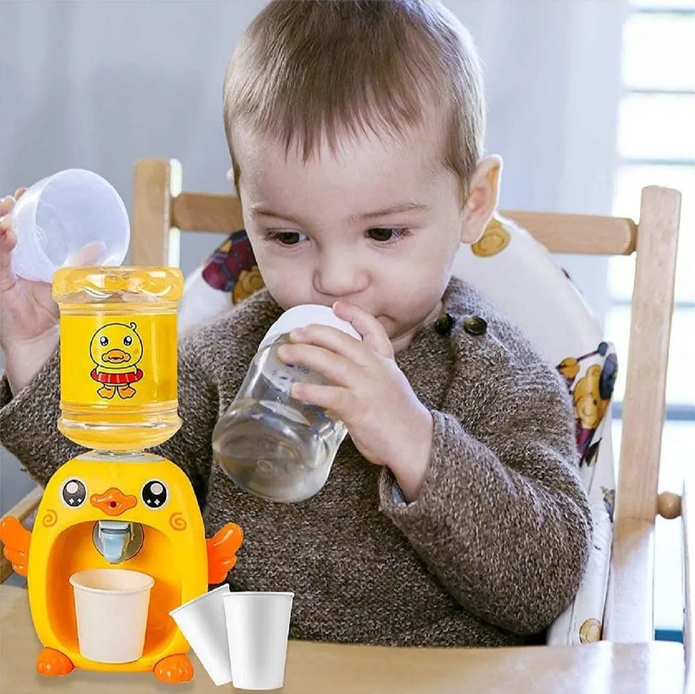 Child using a yellow duck-shaped drink mixer with a cup