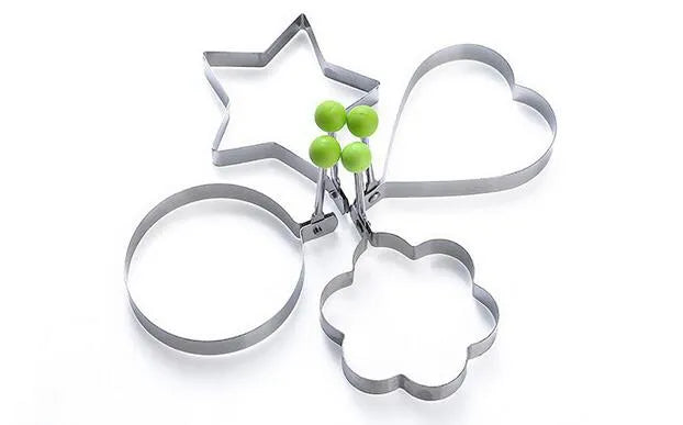 Set of cookie cutters shaped like a star, circle, and flower on a white background.