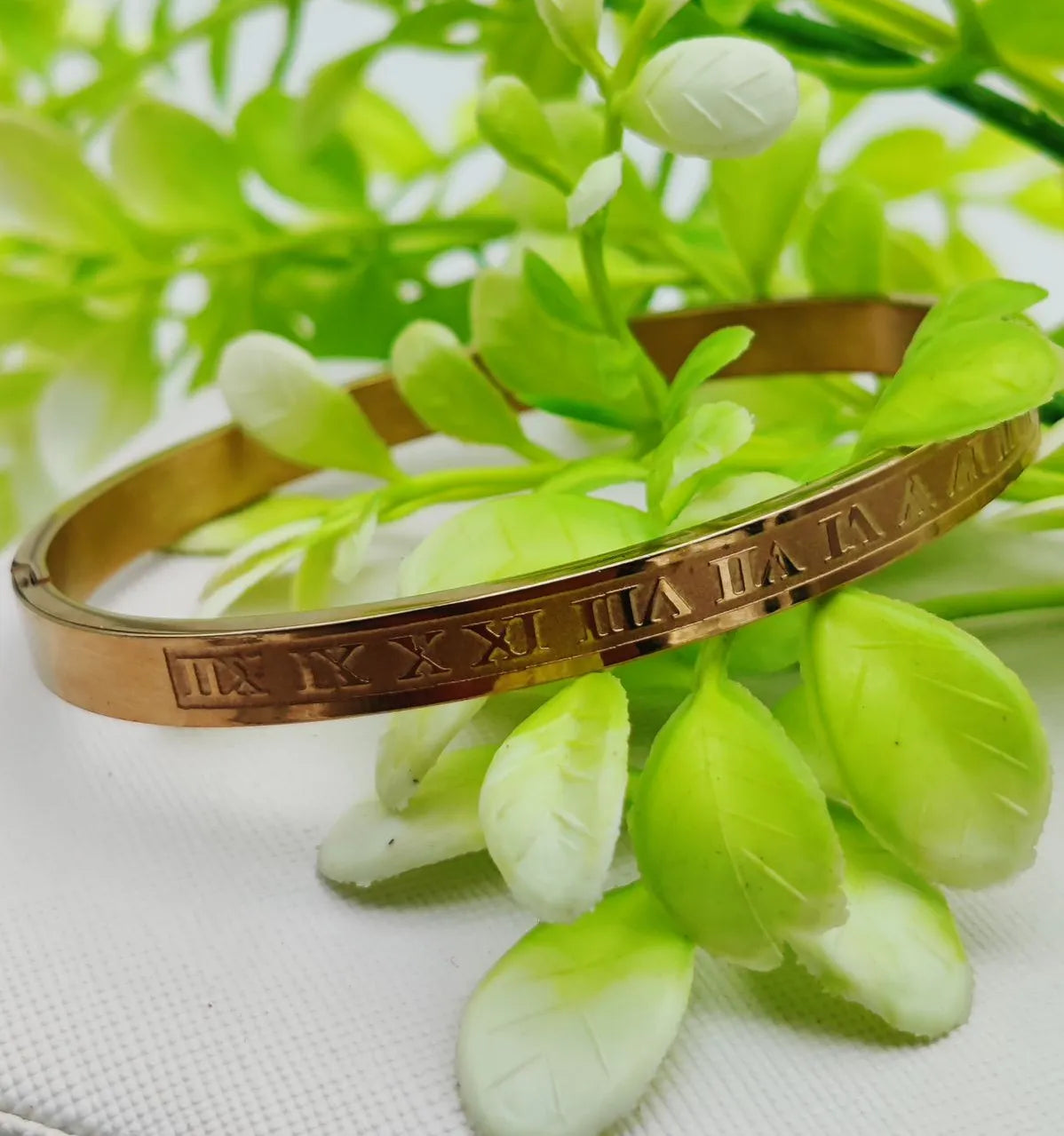 Adjustable gold bracelet featuring Roman numeral accents for a classic and stylish look.