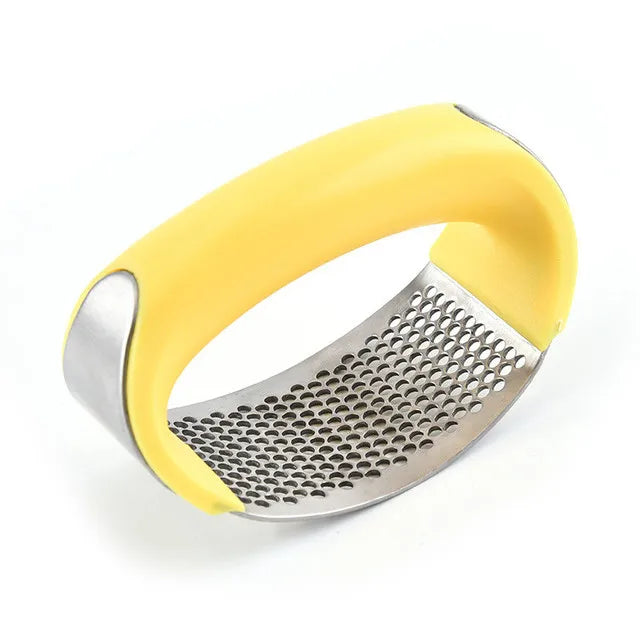 Yellow-handled metal grater on a white background