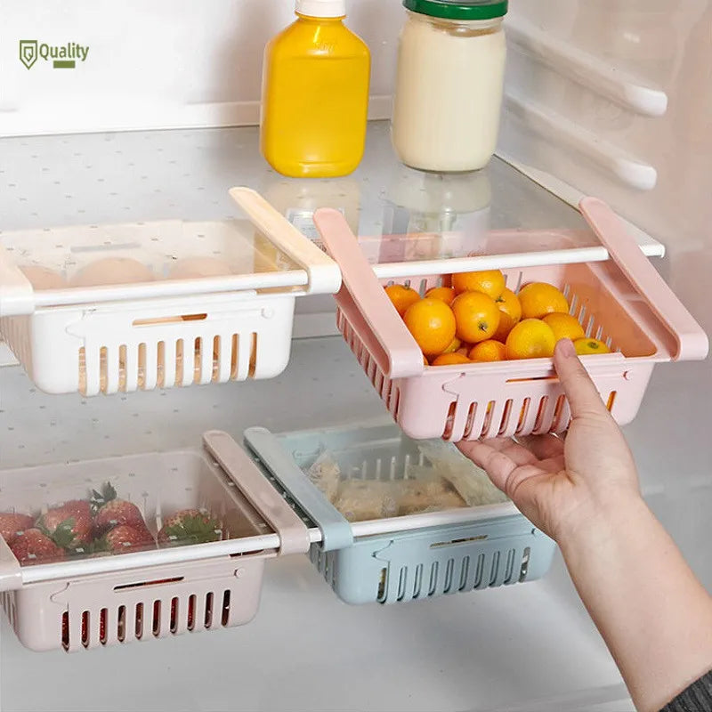 Collapsible fruit and vegetable storage baskets on a refrigerator shelf.