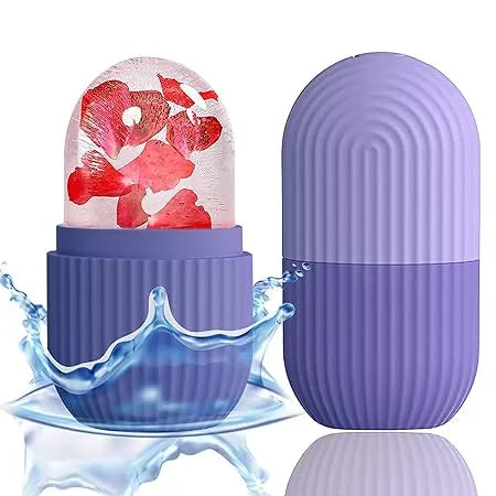 A purple capsule-shaped product shown in two pieces on a white background, with one half open to reveal a clear dome containing red flower petals and a blue water splash effect. The other half stands closed beside it.