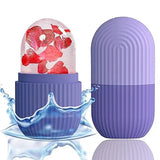 A purple capsule-shaped product shown in two pieces on a white background, with one half open to reveal a clear dome containing red flower petals and a blue water splash effect. The other half stands closed beside it.