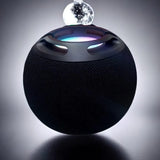 Black spherical device with a glowing interior on a dark background