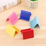 Set of colorful phone stands on a wooden surface