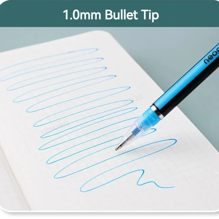 A close-up of a blue and black ballpoint pen writing a blue squiggle on white graph paper, with a dark teal banner at the top reading '1.0mm Bullet Tip'.