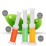 Three syringes with colored liquids on a white background with green leaves.
