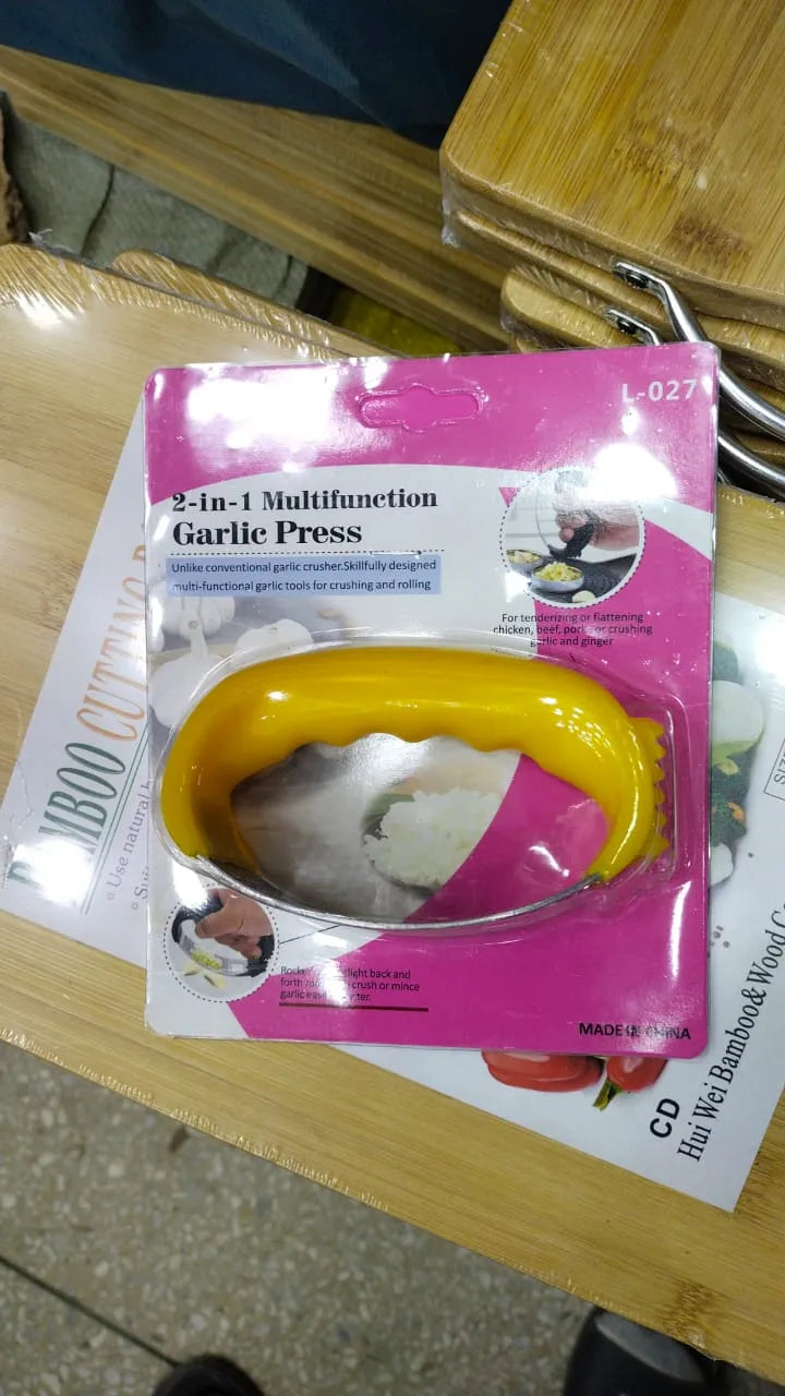 Multifunctional garlic press on a wooden surface with packaging