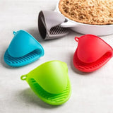 Four colorful silicone baking cups on a white surface with a pie in the background.