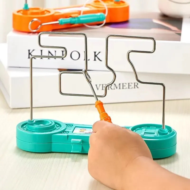 Teal tool with orange handle being used on a white surface with books in the background