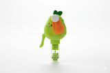 Green and orange toy with a carrot-like top on a white background