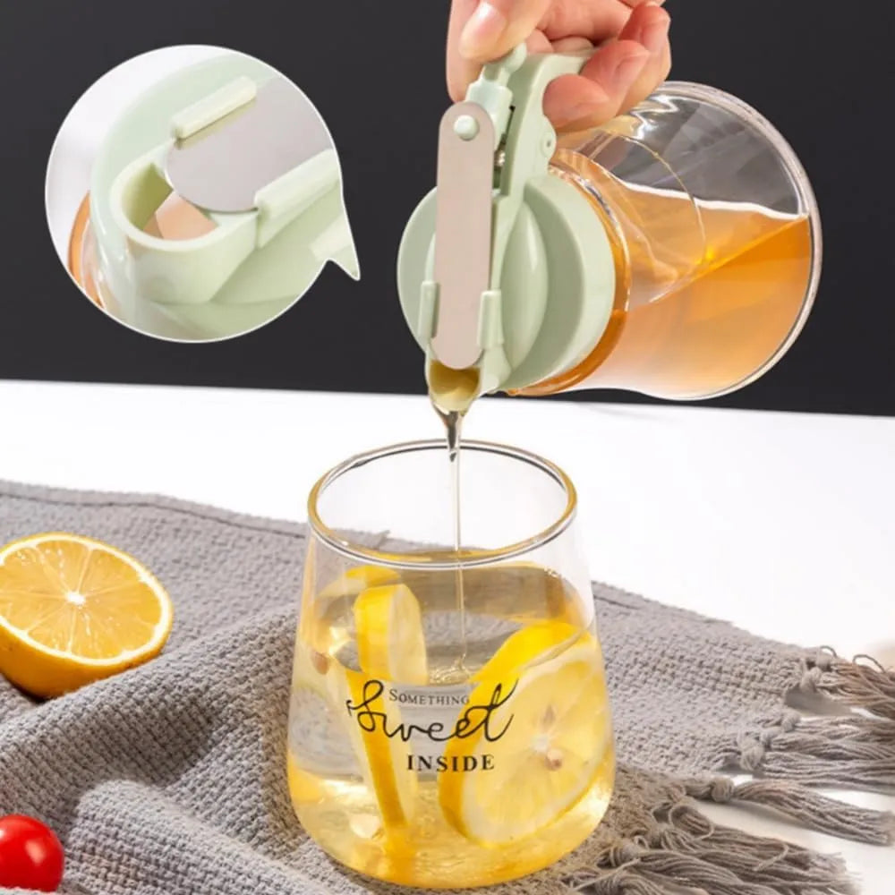 Person pouring a liquid from a small container into a glass with lemon slices, on a textured surface.