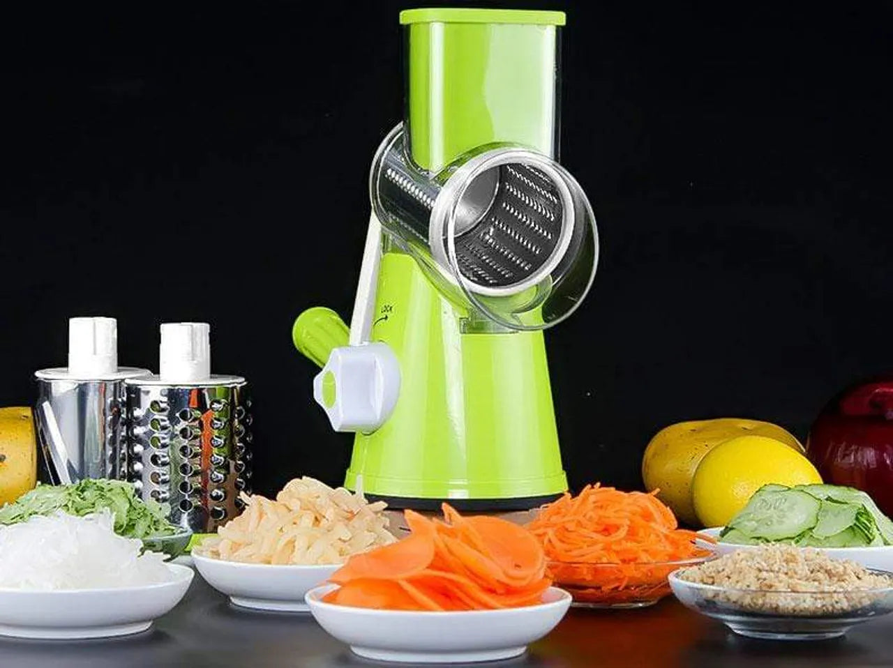 Green manual vegetable spiralizer with sliced vegetables on a dark background