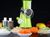 Green manual vegetable spiralizer with sliced vegetables on a dark background
