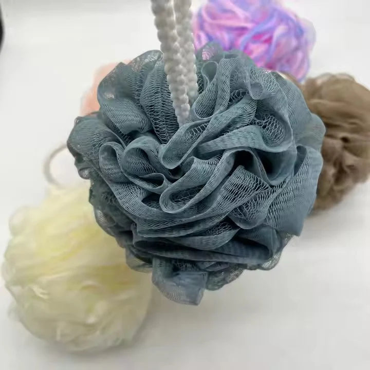 Mesh bath sponge in random color for gentle exfoliation, cleansing, and a refreshing shower experience.