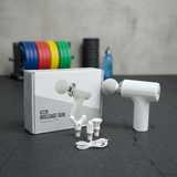 White mini massage gun with accessories
