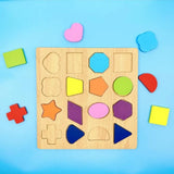 A wooden shape-sorting toy board with colorful geometric pieces arranged around it on a bright blue background.