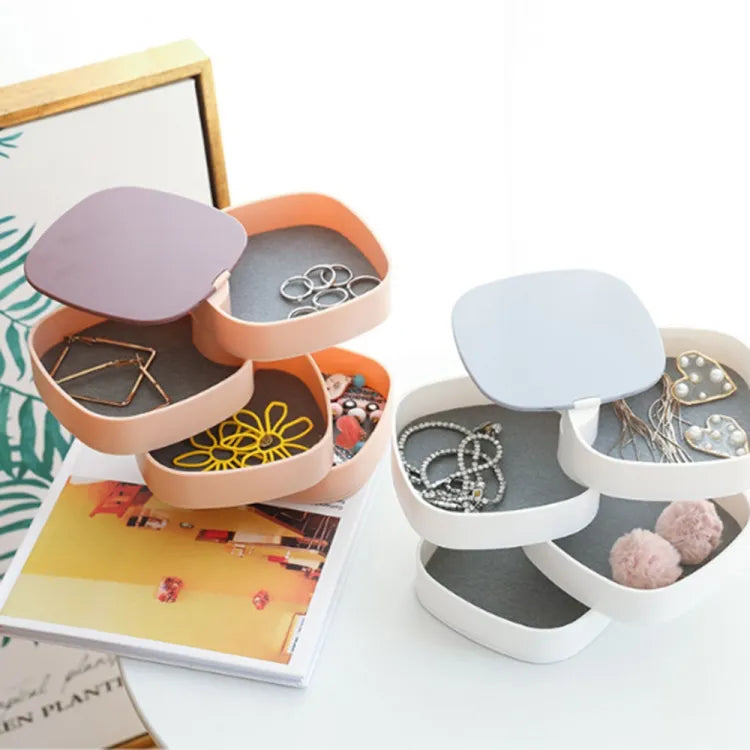 Multi-layer rotating jewellery box for organized storage of earrings, rings, bracelets, and necklaces.