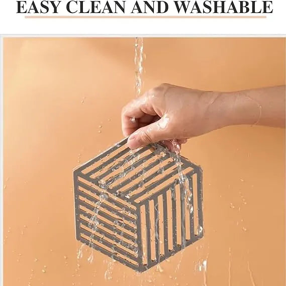 Hand holding a small rectangular object under running water with text 'EASY CLEAN AND WASHABLE' above.