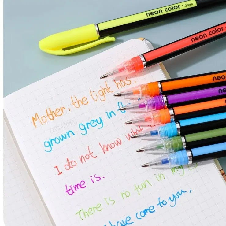 Colorful markers on a notebook with text, against a light blue background