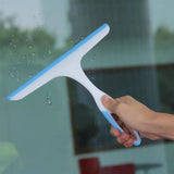 Hand using a blue and white squeegee to clean a glass surface