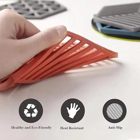 Red silicone mat held by a hand with icons and text indicating features on a light background