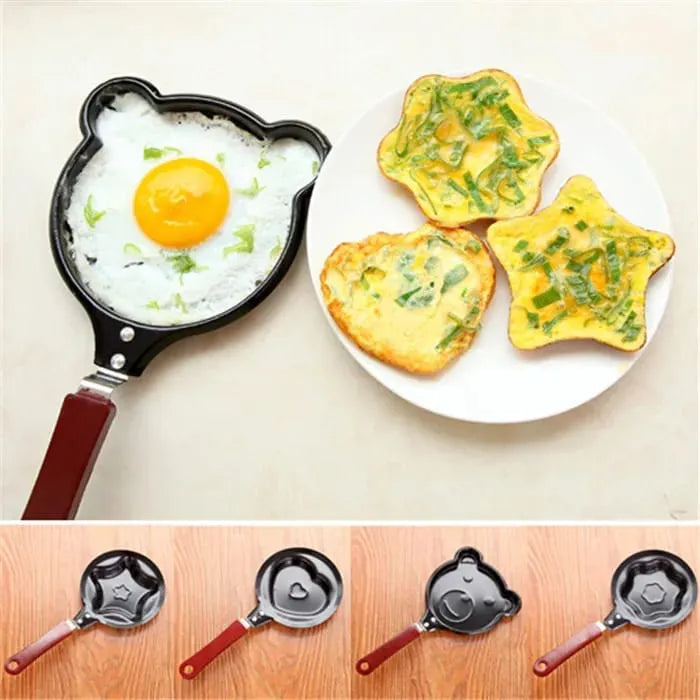 Star-shaped frying pans with cooked eggs and rice on a white plate.