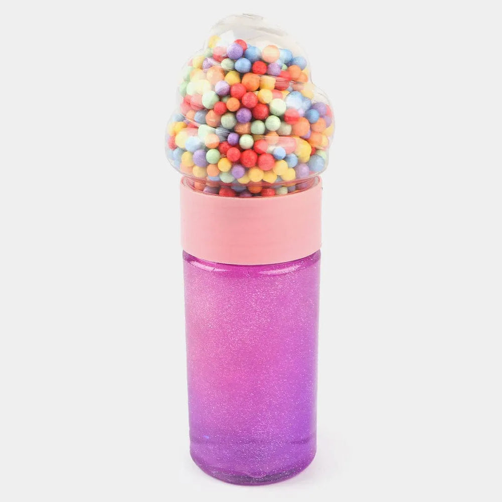 A novelty bottle shaped like a gumball machine, with a glittery purple-to-pink gradient body, a light pink collar, and a clear top filled with multicolored gumball-like beads, shown on a light gray background.