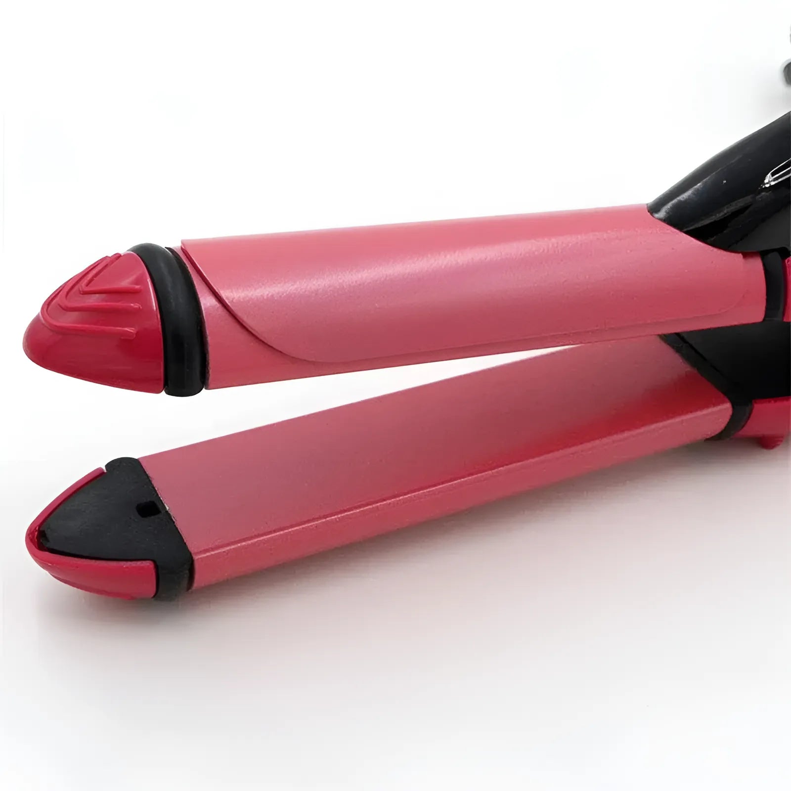 A close-up of a pink and black hair straightener, showing the flat plates and hinge on a clean white background.