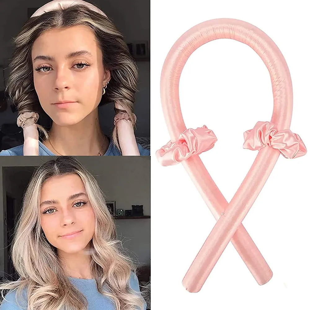 Two women with styled hair and a pink balloon sculpture shaped like a ribbon.