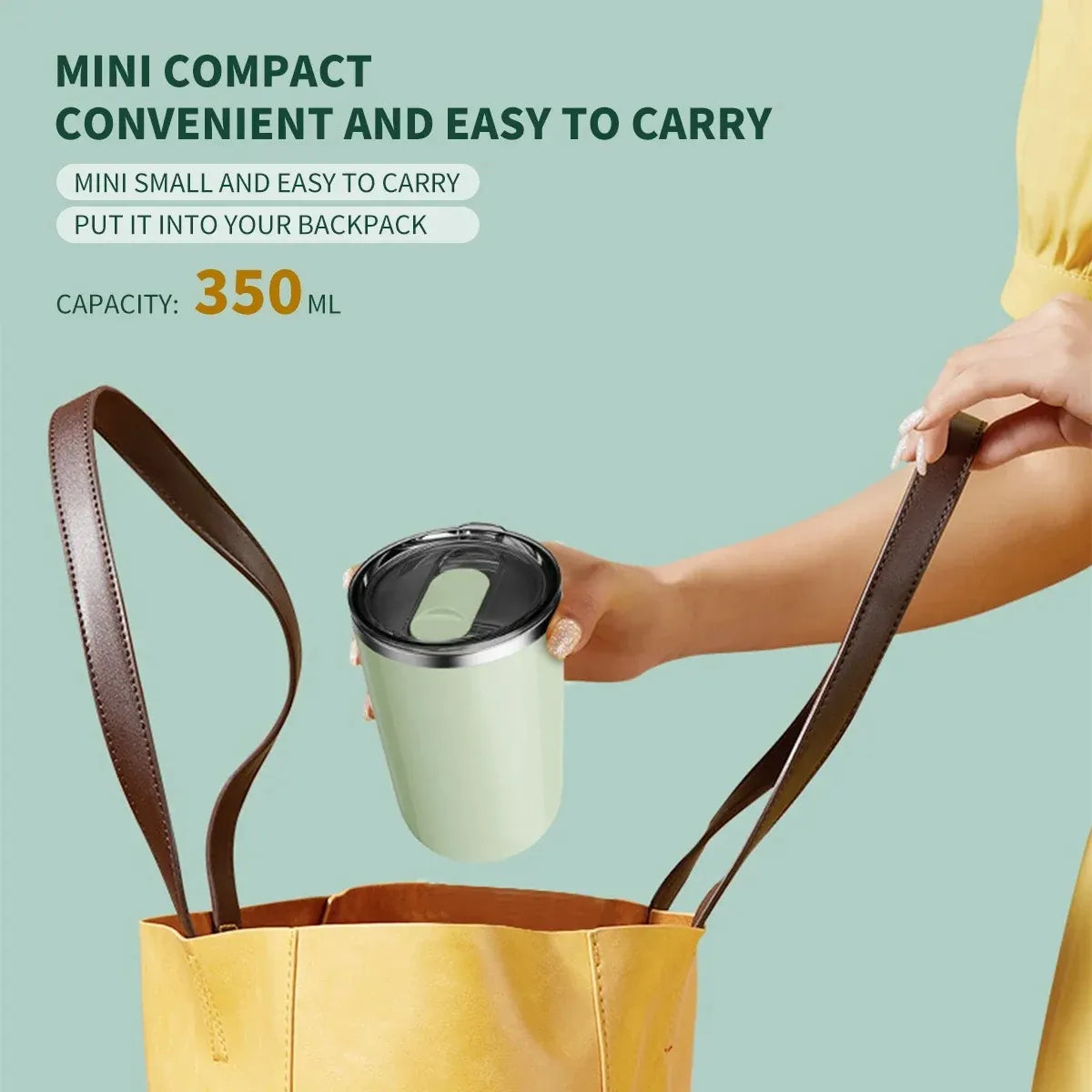 Person holding a green travel mug with a brown strap, placed inside a yellow bag on a light blue background.