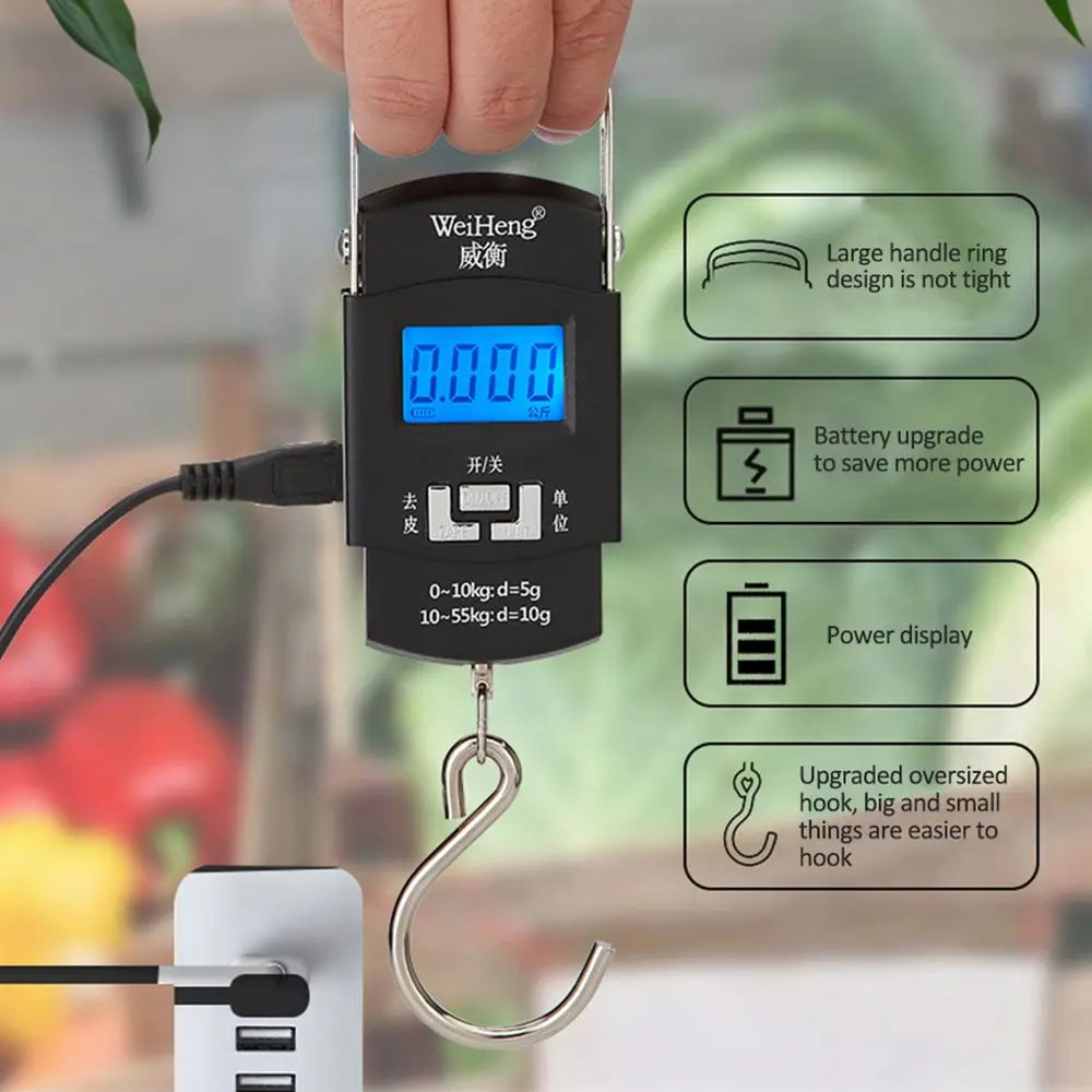 Digital hanging scale with a hand holding it, set against a blurred background of vegetables.