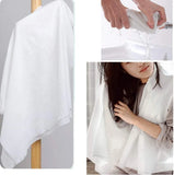 White towel displayed on a wooden rack, being held by hands, and draped over a person.