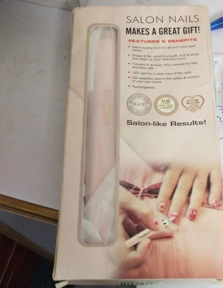 A boxed manicure tool set labeled 'SALON NAILS MAKES A GREAT GIFT!' with a clear window showing a pale pink nail file inside. The package includes text about features and benefits, plus a photo of manicured hands on the front.