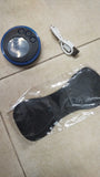 Black and blue electronic device with buttons, USB cable, and clear plastic bag on a tiled floor.